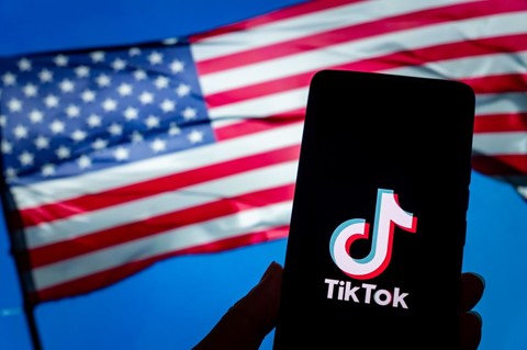 TikTok logo in front of a US flag